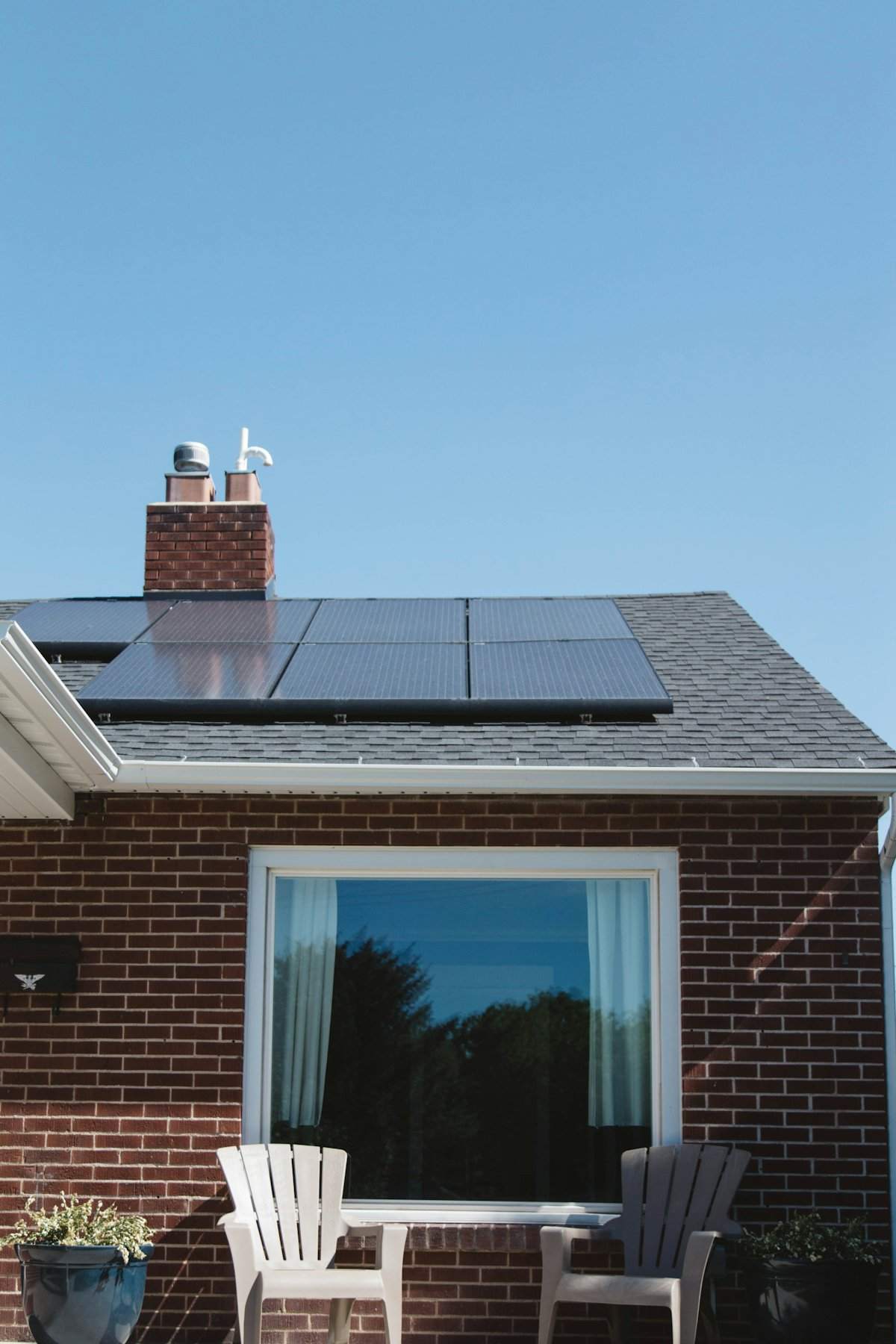 Solar panels on the asphalt shingle roof of a brick home