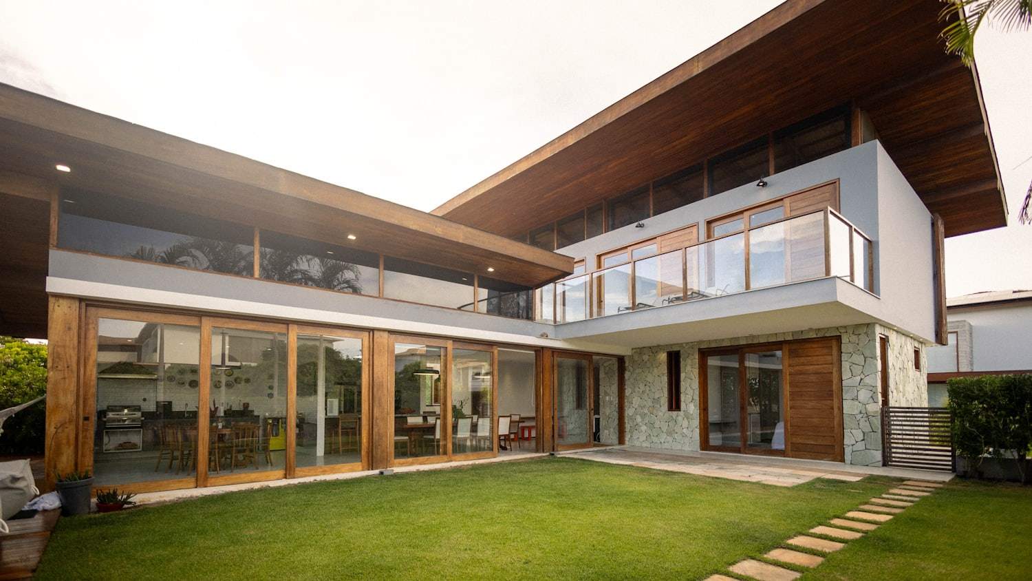 A large custom Greenwood Village home with modern windows and a complex shingle roofline
